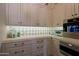 Modern kitchen with custom white cabinetry, granite countertops, mosaic backsplash, and premium appliances at 6322 E Turquoise Ave, Paradise Valley, AZ 85253