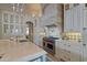 Chef's kitchen features a Wolf range, tile backsplash, and custom cabinets at 6322 E Turquoise Ave, Paradise Valley, AZ 85253