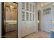 Butler's pantry with custom shelving, cabinets, and tile backsplash at 6322 E Turquoise Ave, Paradise Valley, AZ 85253