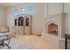 Expansive living room with fireplace, travertine floors, built-in shelving, and abundant natural light at 6322 E Turquoise Ave, Paradise Valley, AZ 85253