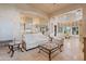 Elegant living room with white sofas, glass coffee tables, and an open layout to the kitchen at 6322 E Turquoise Ave, Paradise Valley, AZ 85253