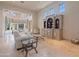 Spacious living room with stone floors, white sofa, and a beautiful bookcase at 6322 E Turquoise Ave, Paradise Valley, AZ 85253