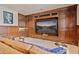 Entertainment space featuring custom wood cabinetry, a large screen television, and comfortable viewing arrangement at 6322 E Turquoise Ave, Paradise Valley, AZ 85253