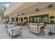 Spacious outdoor living area with comfortable seating, dining space, and elegant travertine flooring, perfect for entertaining at 6322 E Turquoise Ave, Paradise Valley, AZ 85253