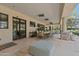 Expansive covered patio with travertine flooring, dining and seating areas, and seamless indoor-outdoor living at 6322 E Turquoise Ave, Paradise Valley, AZ 85253