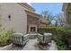 Cozy outdoor patio with stone fireplace and comfortable seating, perfect for relaxing at 6322 E Turquoise Ave, Paradise Valley, AZ 85253
