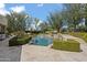 Gorgeous in-ground pool featuring tiered stone waterfalls, surrounded by meticulously manicured hedges and mature trees at 6322 E Turquoise Ave, Paradise Valley, AZ 85253