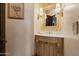 Elegant powder room with an ornate vanity and decorative lighting at 6322 E Turquoise Ave, Paradise Valley, AZ 85253