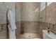 Open tiled shower with clear glass door and diamond decorative tile at 6322 E Turquoise Ave, Paradise Valley, AZ 85253