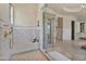 Spacious glass-enclosed shower with built-in bench and decorative tile at 6322 E Turquoise Ave, Paradise Valley, AZ 85253