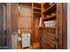 Spacious walk-in closet with custom dark wood shelving, drawers, and ample storage space at 6322 E Turquoise Ave, Paradise Valley, AZ 85253