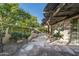 Stone patio with pergola, seating area, and lush landscaping at 6711 E Camelback Rd # 66, Scottsdale, AZ 85251