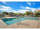 Community pool with lounge chairs and shade structures at 2251 S Annie Ln, Gilbert, AZ 85295