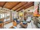 Bright living room with wood beams, stone fireplace, and access to patio at 2546 E Hale St, Mesa, AZ 85213