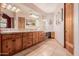 Bathroom with wood cabinets and a large vanity at 2632 E Camina Plata --, Gilbert, AZ 85298