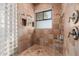 Walk-in shower with glass block wall and built-in shelving at 2632 E Camina Plata --, Gilbert, AZ 85298