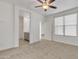 Spacious bedroom with neutral carpet, ceiling fan, and access to the bathroom at 2955 N Augustine --, Mesa, AZ 85207