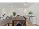 Open concept dining area with a long wooden table and black metal chairs at 2955 N Augustine --, Mesa, AZ 85207