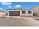 Front view of a single-story home with a two-car garage and desert landscaping at 2955 N Augustine --, Mesa, AZ 85207