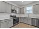 Modern kitchen featuring gray cabinets, stainless steel appliances, and white countertops at 2955 N Augustine --, Mesa, AZ 85207