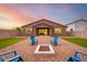 Backyard view of home with firepit and artificial turf at 4969 W Beckham Way, San Tan Valley, AZ 85144