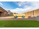 Artificial turf and gravel backyard with fire pit and seating at 4969 W Beckham Way, San Tan Valley, AZ 85144