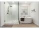 Bathroom with walk-in shower and a large soaking tub at 4969 W Beckham Way, San Tan Valley, AZ 85144