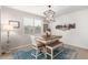 Dining area with rustic table and chairs, blue rug at 4969 W Beckham Way, San Tan Valley, AZ 85144