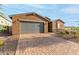 Single-story home with gray garage door and brick accents at 4969 W Beckham Way, San Tan Valley, AZ 85144