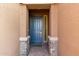 Front entry with gray door and stone accents at 4969 W Beckham Way, San Tan Valley, AZ 85144