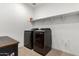 Laundry room with shelving, dark washer and dryer, and wood table at 4969 W Beckham Way, San Tan Valley, AZ 85144