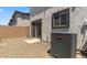 Backyard features stucco walls, an AC unit, gravel, patio, and sliding glass door at 7450 S 75Th Dr, Laveen, AZ 85339