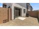 Backyard with a stucco wall, gravel, patio, and sliding glass door at 7450 S 75Th Dr, Laveen, AZ 85339
