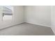 Carpeted bedroom with a large window allowing ample natural light, neutral paint, and minimal design at 7450 S 75Th Dr, Laveen, AZ 85339