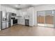 Modern kitchen featuring stainless steel appliances, white cabinetry, and an adjacent sliding door at 7450 S 75Th Dr, Laveen, AZ 85339