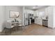 Kitchen with stainless steel appliances, white cabinetry, and modern finishes next to a dining table at 7450 S 75Th Dr, Laveen, AZ 85339