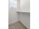 Image shows an empty walk-in closet with neutral carpet and a window with blinds at 7450 S 75Th Dr, Laveen, AZ 85339