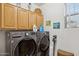 Laundry room with LG washer and dryer, and wood cabinets at 10873 E Salt Bush Dr, Scottsdale, AZ 85255