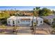 Home with southwestern architecture boasts a tile roof, a two-car garage, and mature palm trees at 14211 N Fountain Hills Blvd # B, Fountain Hills, AZ 85268