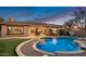 Stunning backyard oasis featuring a sparkling pool, patio, and lush landscaping at 1840 W Sierra Sunset Trl, Phoenix, AZ 85085