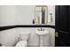 Modern powder room with pedestal sink and dark accents at 1840 W Sierra Sunset Trl, Phoenix, AZ 85085