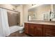 Bathroom with shower/tub combo and wood cabinets at 1840 W Sierra Sunset Trl, Phoenix, AZ 85085