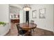 Dining room features a round wooden table, two mirrors hanging on the wall, and tile floors at 1840 W Sierra Sunset Trl, Phoenix, AZ 85085