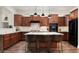 Spacious kitchen features an island with leather stools, stainless appliances, and pendant lighting at 1840 W Sierra Sunset Trl, Phoenix, AZ 85085