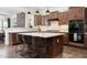 Beautiful kitchen features large island with seating, stone accent wall, and stainless steel appliances at 1840 W Sierra Sunset Trl, Phoenix, AZ 85085