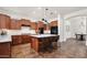 Spacious kitchen featuring a large island with pendant lights, stainless appliances, and tile floors at 1840 W Sierra Sunset Trl, Phoenix, AZ 85085