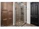 Glass enclosed shower featuring tile walls and flooring, stainless fixtures, and black door at 1840 W Sierra Sunset Trl, Phoenix, AZ 85085