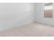 Bright, neutral-toned bedroom with carpeted floors and a large window at 23411 W Albeniz Pl, Buckeye, AZ 85326