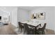 Stylishly staged dining area with a marble-topped table, six chairs, and modern wall art at 23411 W Albeniz Pl, Buckeye, AZ 85326