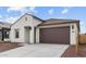 Attractive single Gathering home with a two-car garage, stucco exterior, and desert landscaping at 23411 W Albeniz Pl, Buckeye, AZ 85326